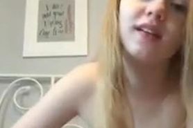 a tiny blonde playing for her fans on webcam