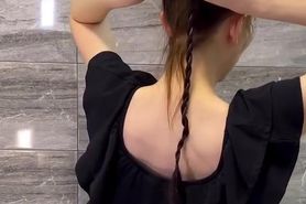 Brushing her silky hair to a ponytail