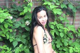 Asia girl tries to stretch her pussy with a beer bottle
