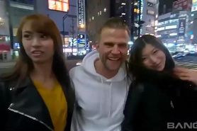 Two Japanese serve a white quy