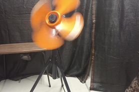 A cross-dressing guy whipping with rubber attached to t